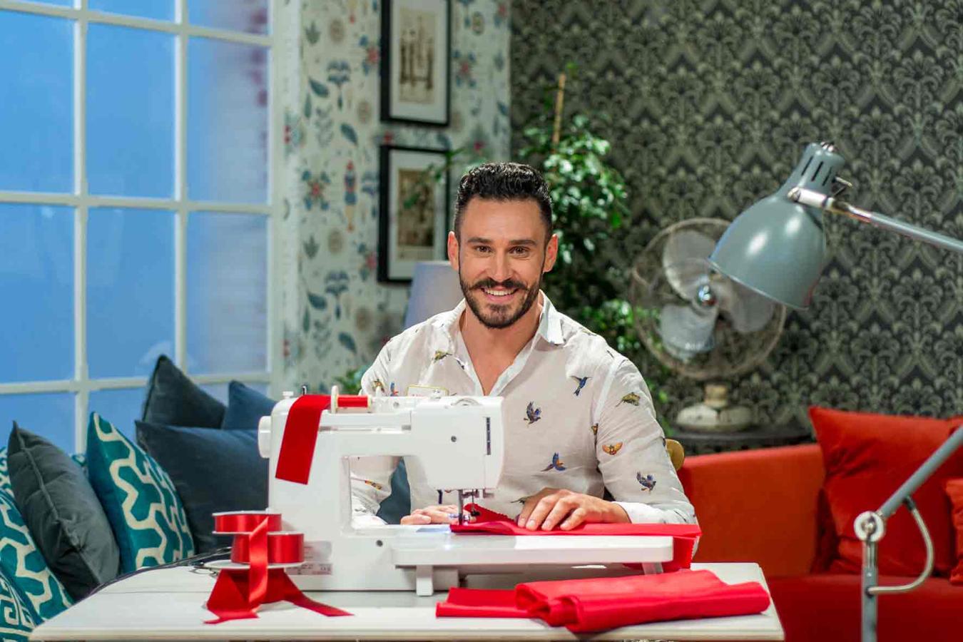 Antonio, profesor de dibujo natural de Almería y concursante del 'talent' de TVE 'Maestros de la costura', posa detrás de su máquina de coser.