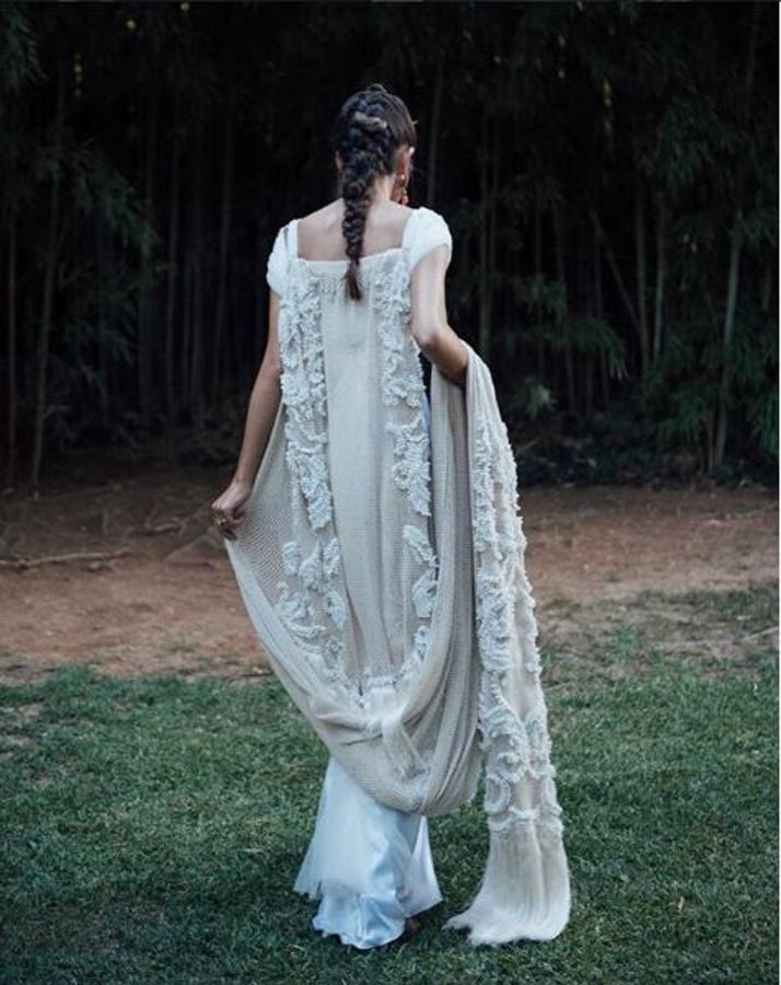 Helena Mareque es una de nuestras diseñadoras favoritas y no le quitamos el ojo de encima a su cuenta de Instagram, sobre todo estos meses de buen tiempo en los que no para de vestir a novias de diferentes estilos. De este último vestido nos encanta la capa que lleva a modo de mantón con flecos.