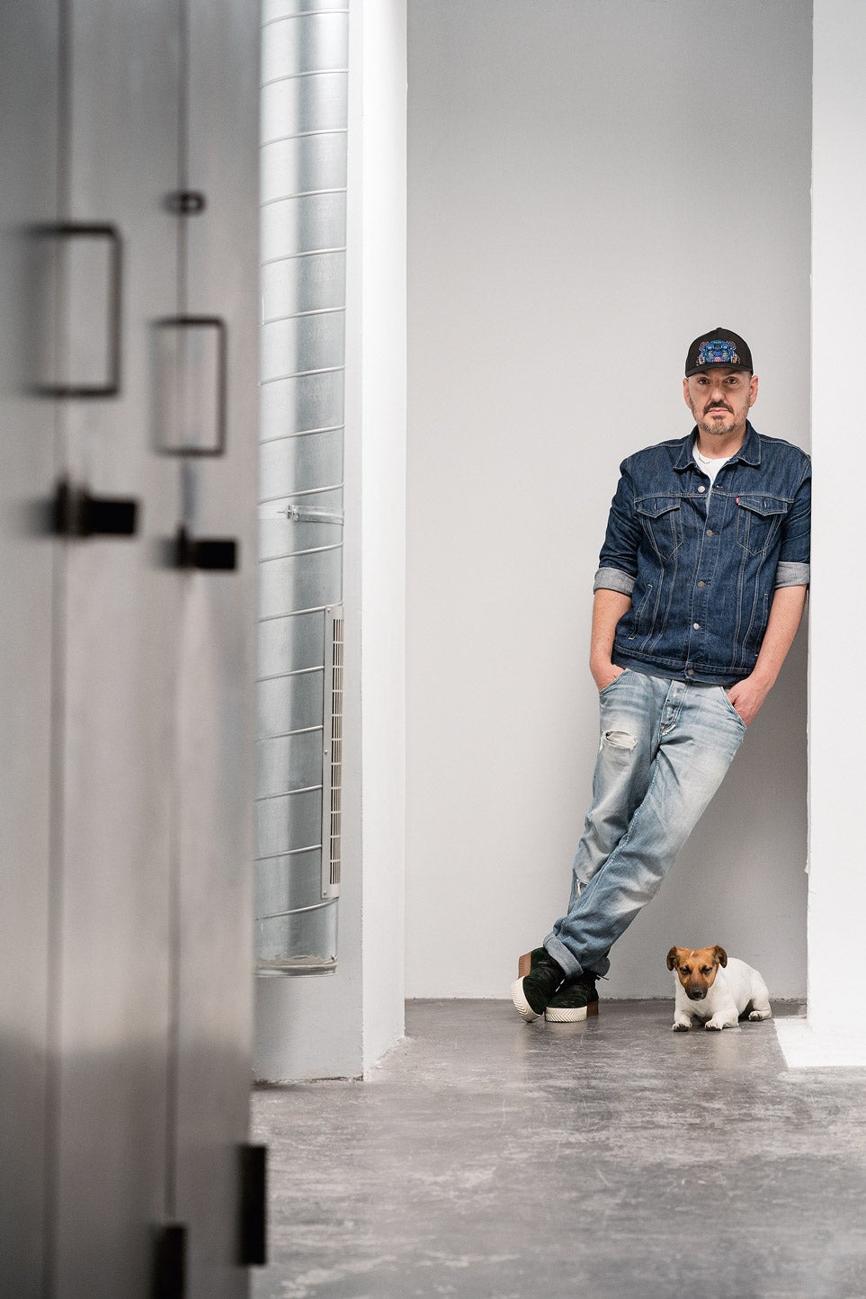 El diseñador Juan Duyos acude cada mñana a su taller en muy buena compañía: se llama Cara y es una perrita jack russell que hace las delicias de todo su equipo. Va con ella a todas partes, incluso a las reuniones de trabajo. Para saber más sobre el diseñador y su vida con Cara  pincha aquí y lee la entrevista completa.  (Duyos lleva camiseta, jeans y cazadora de Levi's).