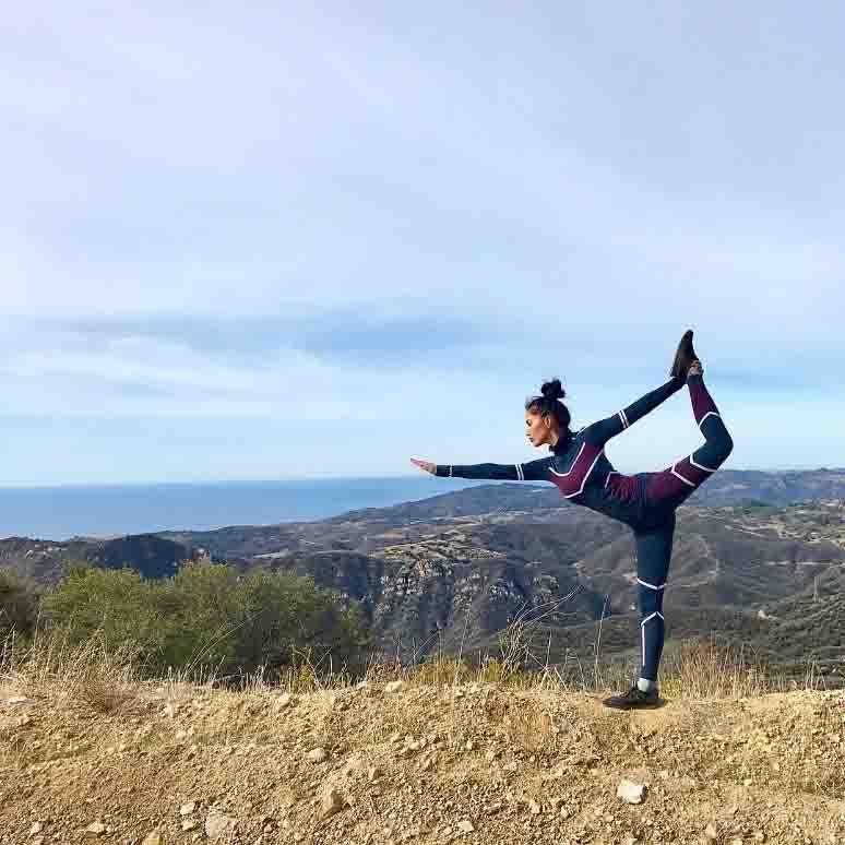 Nicole Scherzinger elige sin duda uno de los sitios más perfectos para hacer yoga. Mantener su figura tiene el secreto del equilibrio del yoga detrás. En la imagen muestra además una de las posturas más reproducidas por las famosas en las redes: Dandayamana Dhanurasanao o postura de arco en pie.