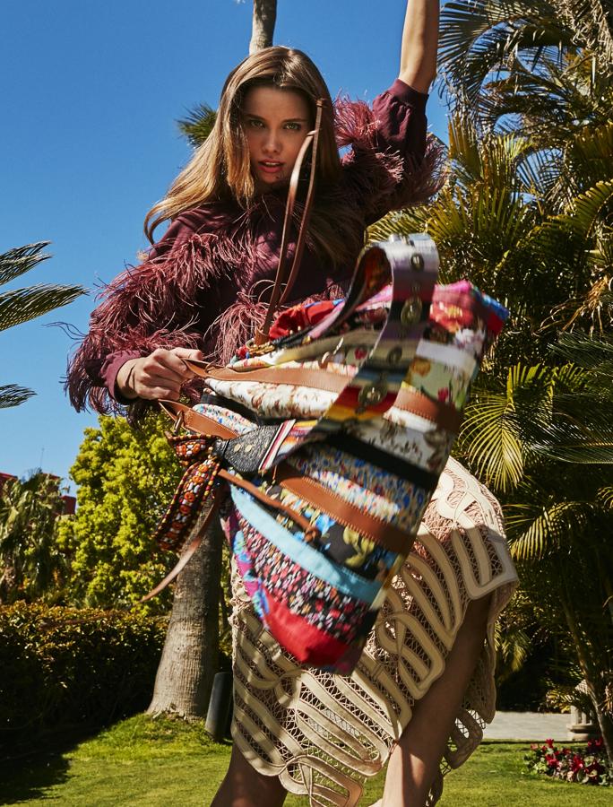 Top con plumas de Brunello Cucinelli y falda de Hermès. Bolso de Zara y correa multicolor de Dior. Los pendienets y las sandalias son de Versace.