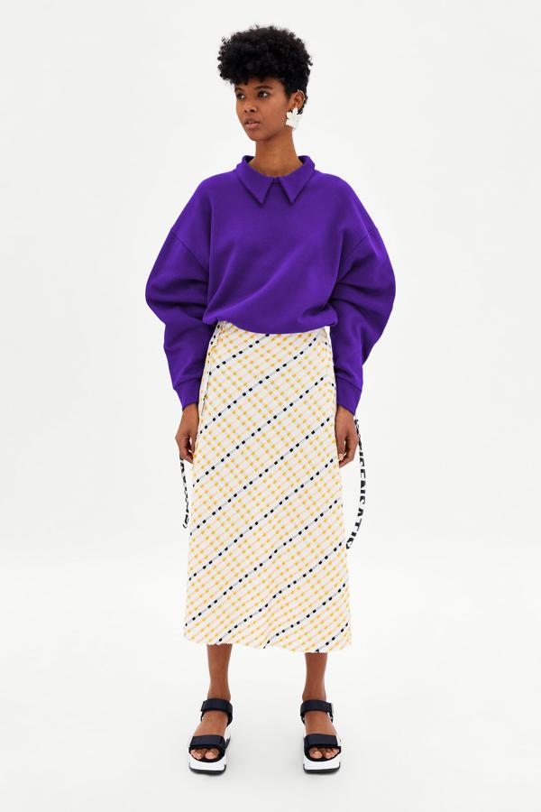 Con efeto 'tweed', de largo midi y original combinación bicolor. El precio de esta falda en las últimas rebajas de Zara pasa de 19.95 a 7.99 euros.