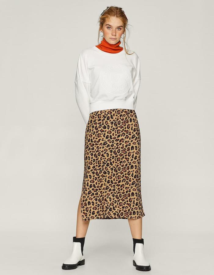 Este fantástico estilismo de tres piezas no puede ser más accesible: sudadera con relieve (12,99 euros), falda animal print recta (19,99 euros) y cisne rojo (12,99 euros).