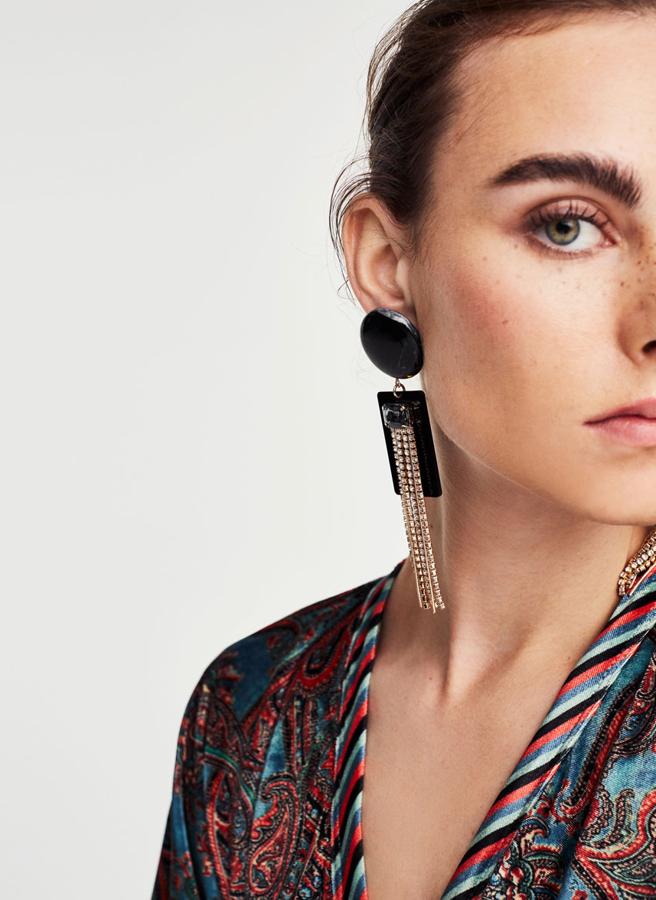 Con un diseño geométrico y un adorno de piedra engarzada y flecos con pedrería. Cierre pi. (39 euros).