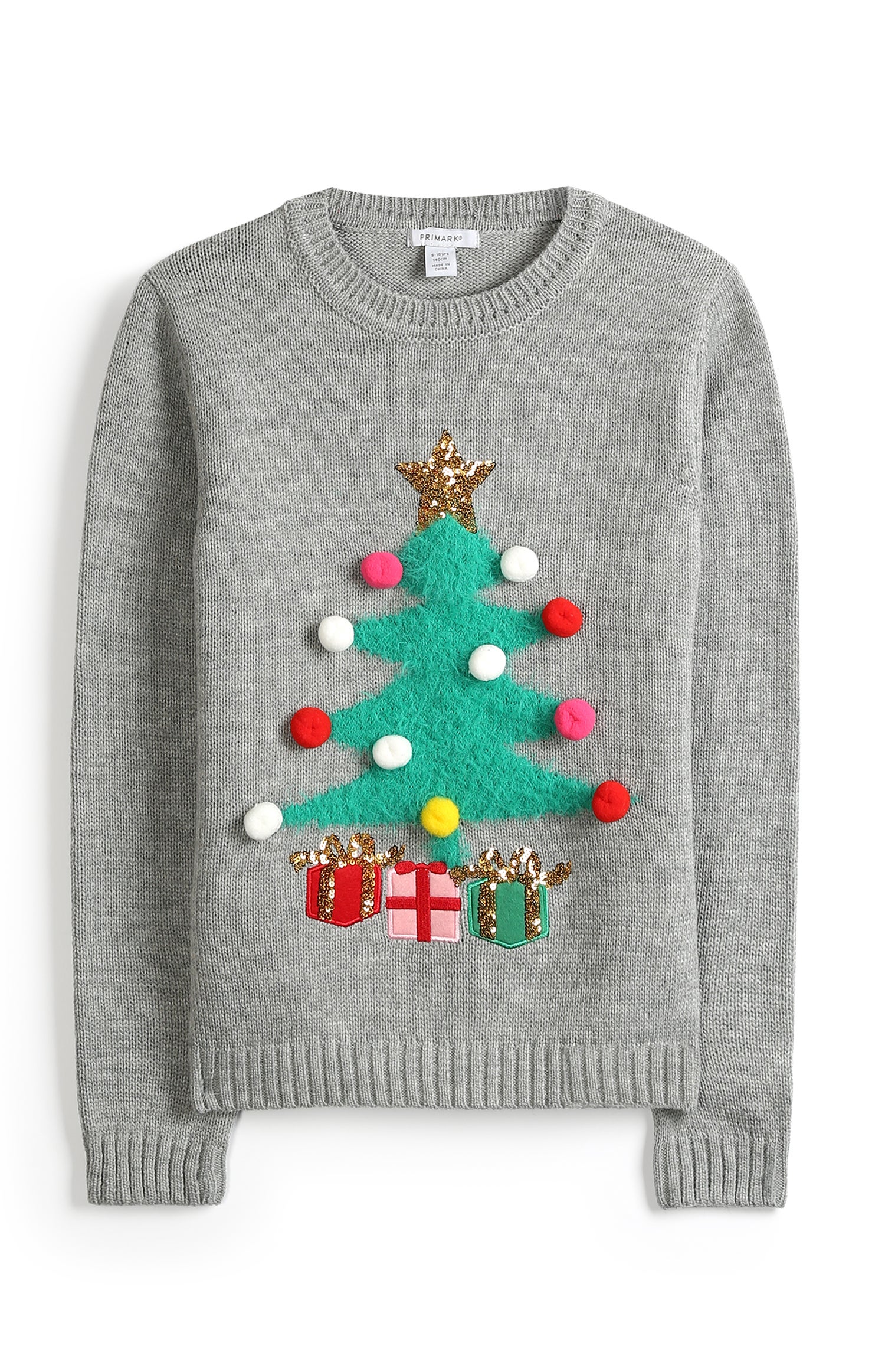Este jersey con el abeto de Navidad y los pompones como bolitas del árbol es absolutamente genial. ¡Nos encanta!