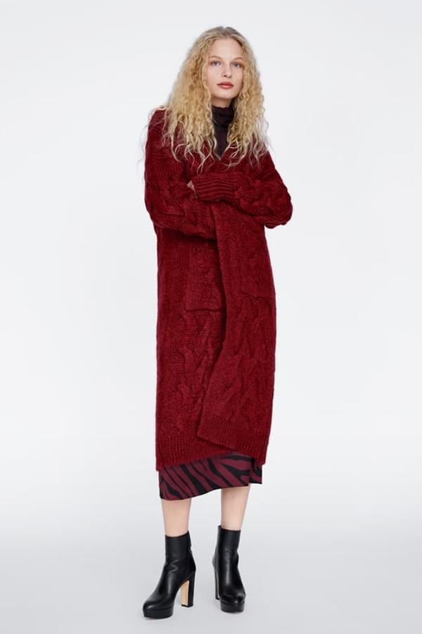 Abrigo amplio de punto a ochos y manga larga. Lleva bolsillos frontales de plastrón y remates acabados en "rib" (Zara, 59,95 euros).