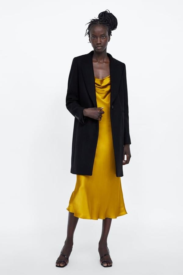 Abrigo negro con cierre frontal y botón, 89,95 euros.