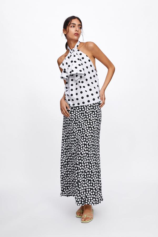 Top de lunares con lazada y escote halter (29.95 euros) combinado con maxi falda de lunares (39.95 euros en Zara).