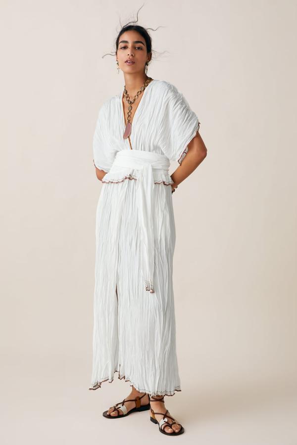 Este vestido en edición limitada de Zara tiene la particularidad de estar confeccionado en un precioso tejido arrugado, que termina en pespuntes contrastados en marrón. Lleva escote de pico profundo, gran cinturín y manga corta amplia (Zara, 99,95 euros).