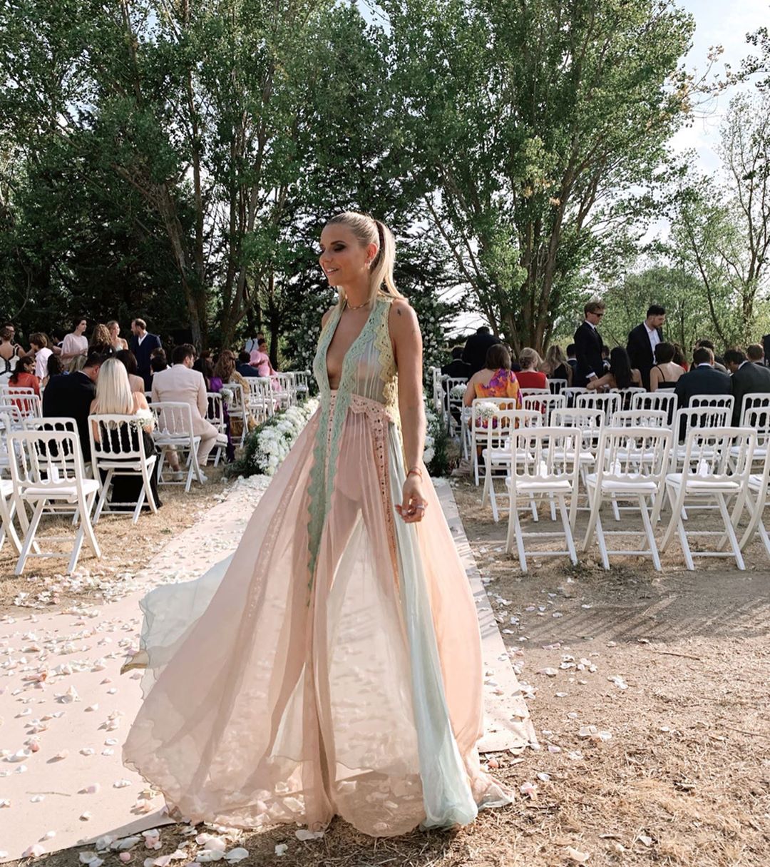 La conocida influencer internacional Verónica Ferraro ha sorprendido en la boda de Alexandra Pereira con un espectacular diseño vaporoso transparente con bordados, donde se han combinado algunos colores pastel. El escote hasta la cintura le daba un toque muy sexy y ha sido confecionado por Alberta Ferreti. Para lucirlo de forma más elegante ha optado por una coleta alta.