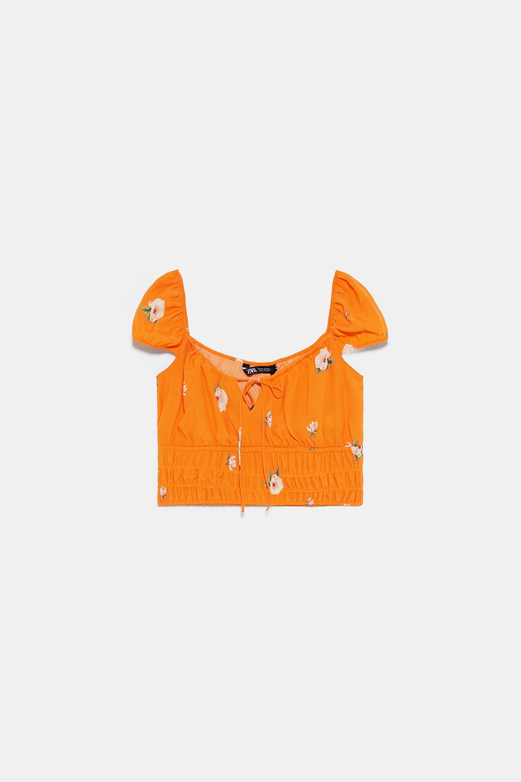 Top cropped estampado en color naranja con flores: 9,99 euros.