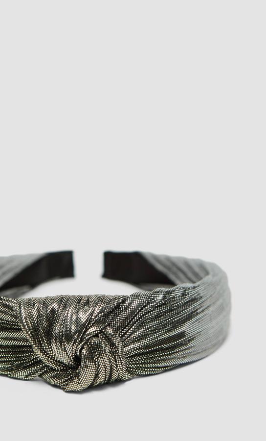 Recubierta de tejido metalizado, con nudo superior, esta diadema de Stradivarius cuesta 5,99 euros.