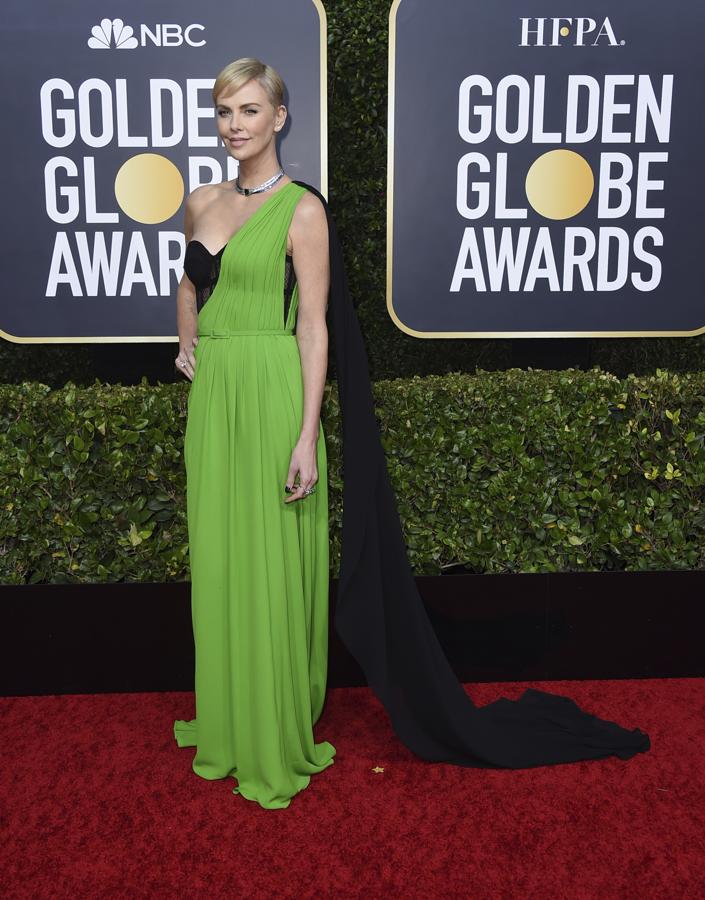 La actriz sudafricana Charlize Theron lució un vestido verde lima de Christian Dior, con corpiño negro y capa negra en cascada.