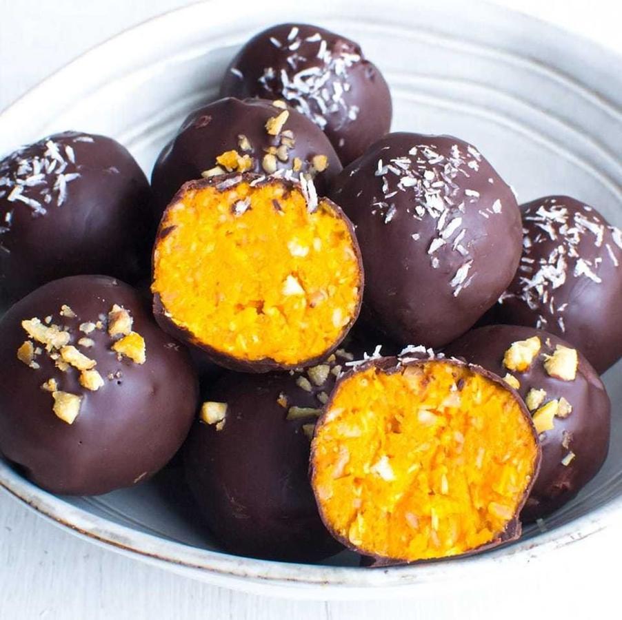 Ingredientes  (13-15 uds):-1 boniato (aprox 300 gr)-8-10 castañas-15 gr coco rallado-80 gr chocolate 85%-10 gr aceite de coco virgen extra-Canela en polvo-Clavo en polvoPreparación:- Precalentar el horno a 200 °C.- En una bandeja de horno colocar el boniato cortado en rodajas finas e uniformes y las castañas con un corte pequeño. Asar aprox. 20-25 minutos.- Picar las castañas ya frías y peladas.- En un bol mezclar el boniato, las castañas picadas, el coco y las especias. Formar bolitas pequeñas y reservar.- Para la cobertura, fundir el chocolate en el microondas junto con el aceite de coco en intervalos menores de 30 segundos.- Bañar los bombones, decorar con castaña o coco y dejar enfriar en una bandeja con papel vegetal.