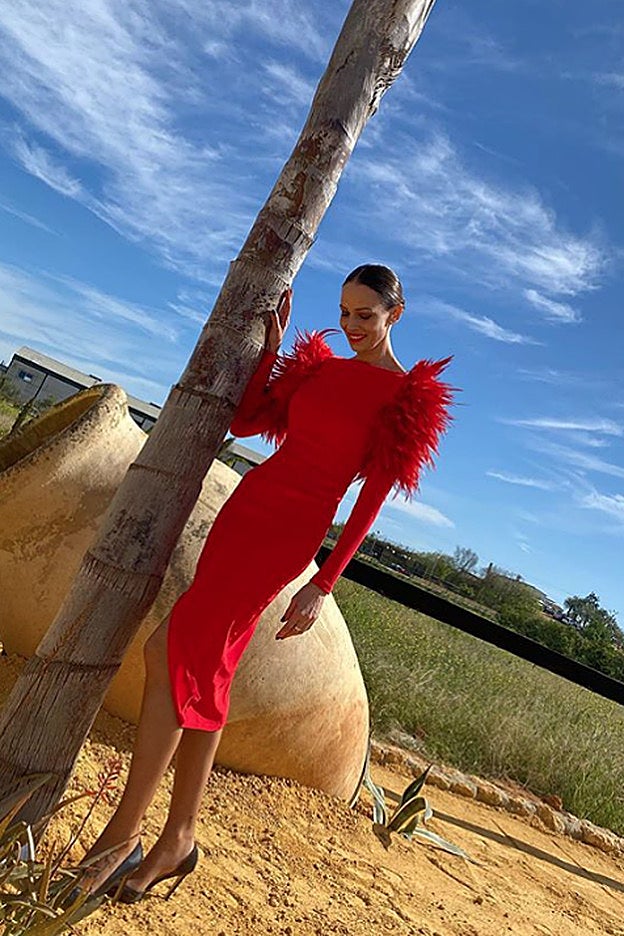 El impresionante vestido rojo con plumas que lleva Eva González es de la firma sevillana Mercedes de Alba.