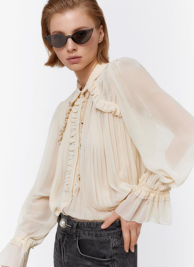 Con el cuerpo plisado y volantes en hombros y mangas, este modelo es de Uterqüe (79 euros).