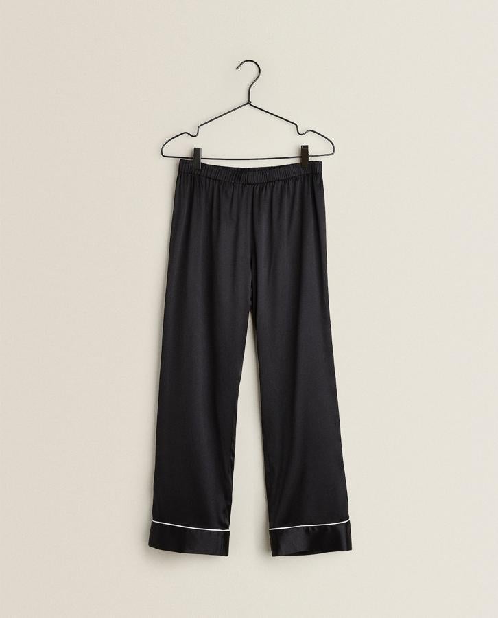 El pantalón de satén lo puedes combinar combinar de muchas formas, icnluso, son una sudadera gris. De Zara Home, (59,99 euros).