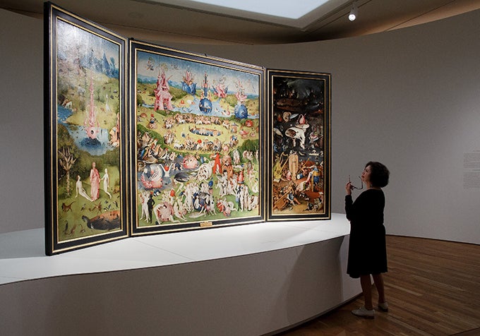 MADRID, SPAIN - MAY 27:  A woman looks at 'The garden of earthly delights triptych' by Dutch painter Hieronymus Bosch during a press preview of the 'El Bosco' 5th Centenary Anniversary Exhibition at El Prado Museum on May 27, 2016 in Madrid, Spain. The Prado Museum will host the exhibition celebrating the work of Dutch painter Hieronymus Bosch to mark 500 years since his death in 1516. It consists of sixty-five works of art loaned by collections based all over the world, and will be open to the public by May 31 until Septembr 11, 2016.  (Photo by Pablo Blazquez Dominguez/Getty Images)