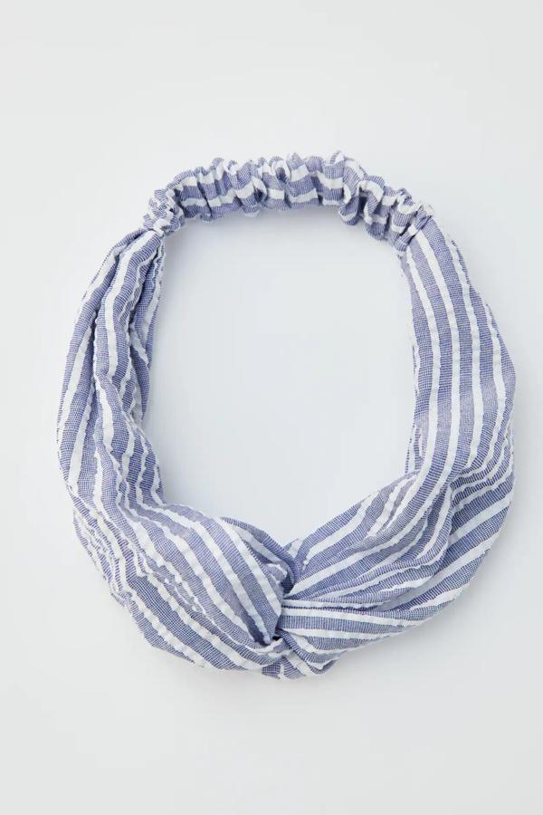 En color azul con rayas blancas, esta cinta para el pelo de Pull & Bear tiene un precio de 4,99 euros.