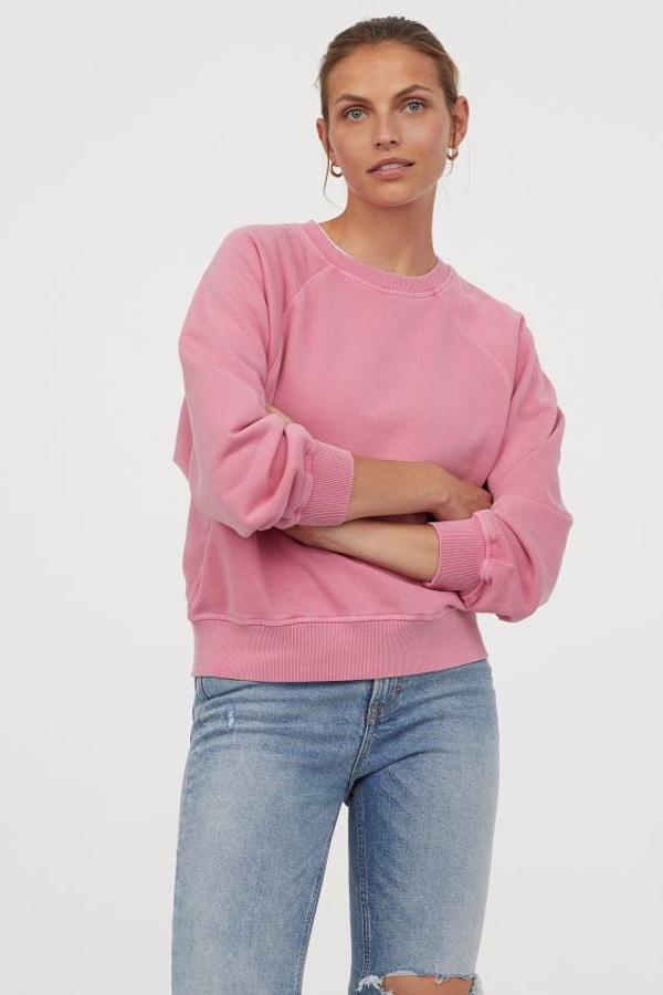 En mezcla de algodón suave con mangas raglán, esta sudadera en color rosa de H&M viene con cuello, puños y bajo en punto elástico de canalé. Tiene un precio de 29,99 euros y está disponible entre las tallas XS y XXL.