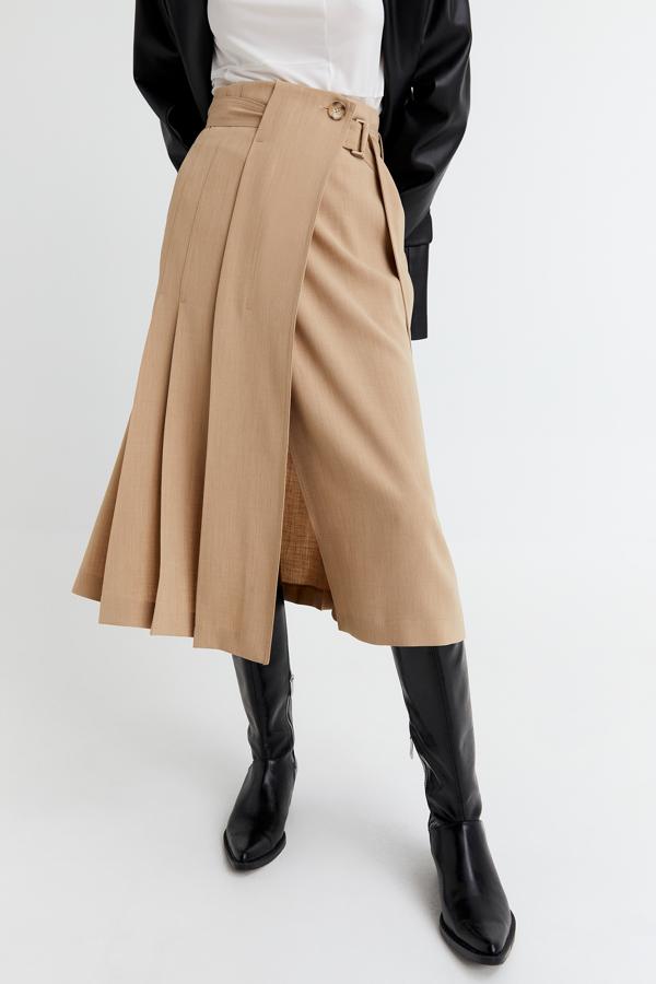 En Sfera hemos encontrado esta original propuesta en color camel con diseño de tablones, más anchos que los plisados, y cinturón a tono con hebilla y botón. Con un precio de 59,99 euros está disponible en las tallas XS, S y M.