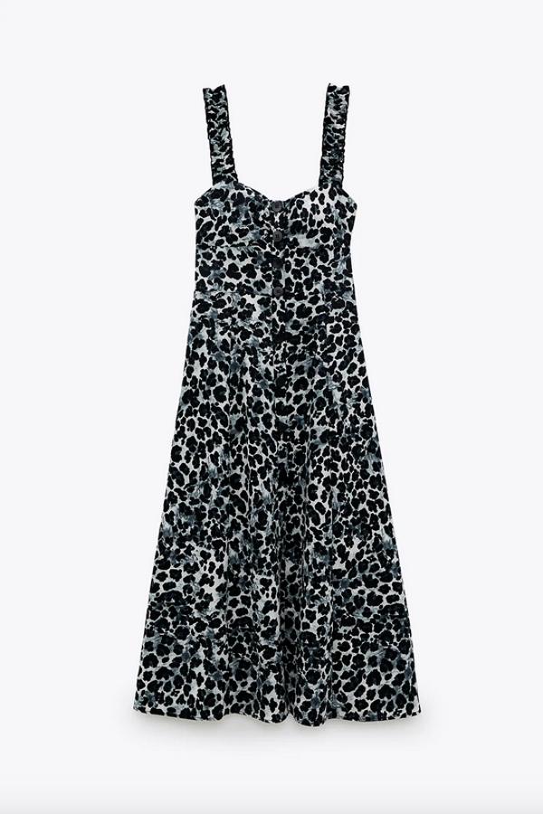 Diseño midi para este bonito vestido de Zara con estampado leopardo en tonos negros y grises. Viene con escote pico con frunces y tirantes anchos con volantes, además de cierre frontal con botones. Cuesta 29,95 euros y está disponible entre las tallas XS y XL.