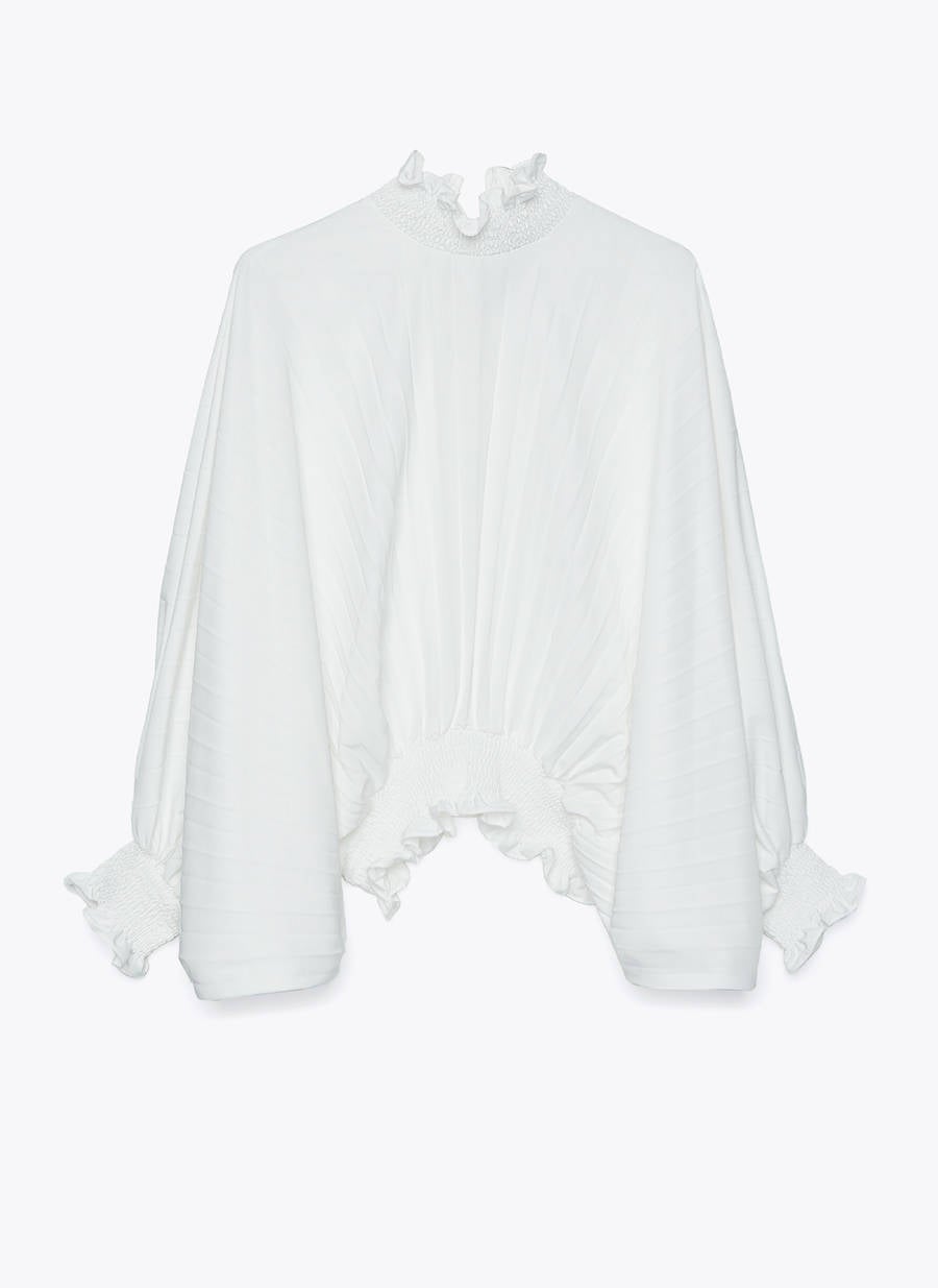 Camisa plisada con cuello alto en tono blanco, un clásico que no pasa de moda y que eleva a otro nivel cualquier look improvisado. Antes: 89 euros. Ahora: 34,95 euros.