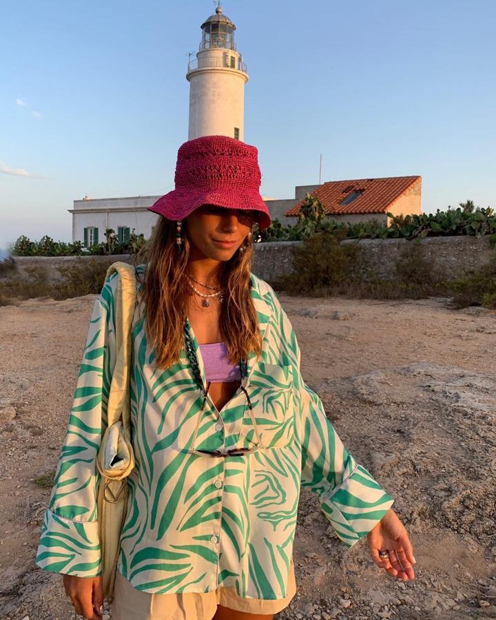 Haz como Sara Baceiredo y combina tu traje de baño con una camisa ancha semiabierta para dar una segunda vida a esta prenda con una versión más informal. Añade también unos shorts y un bolso de tela tipo shopper como el que ella lleva de It's Lava.