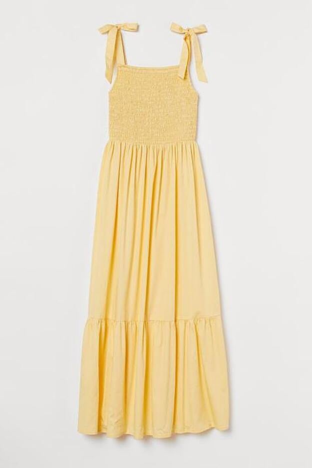Vestido vaporoso en algodón amarillo de H&M.