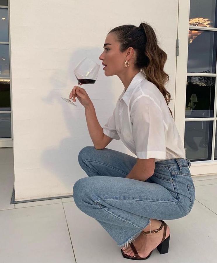 Una buen aopció para el entretiempo, es optar po un modelo de camisa blanca de manga corta com oha hecho Lida. Obtendrás así el equilibrio perfecto con los jeans largos e irás igual de acertada.