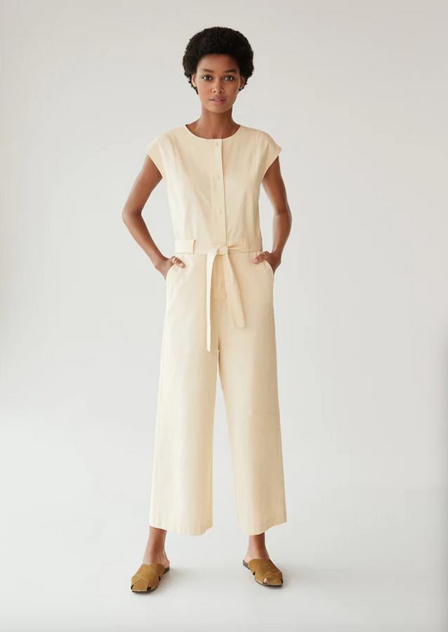 En amarillo pastel, con cuello redondo y mangas cortas, este mono largo de Mango con bolsillos de parche en la parte posterior y laterales, viene con cierre de botones en la parte delantera. Cuesta 39,99 euros y está disponible en las tallas XS, S y M.