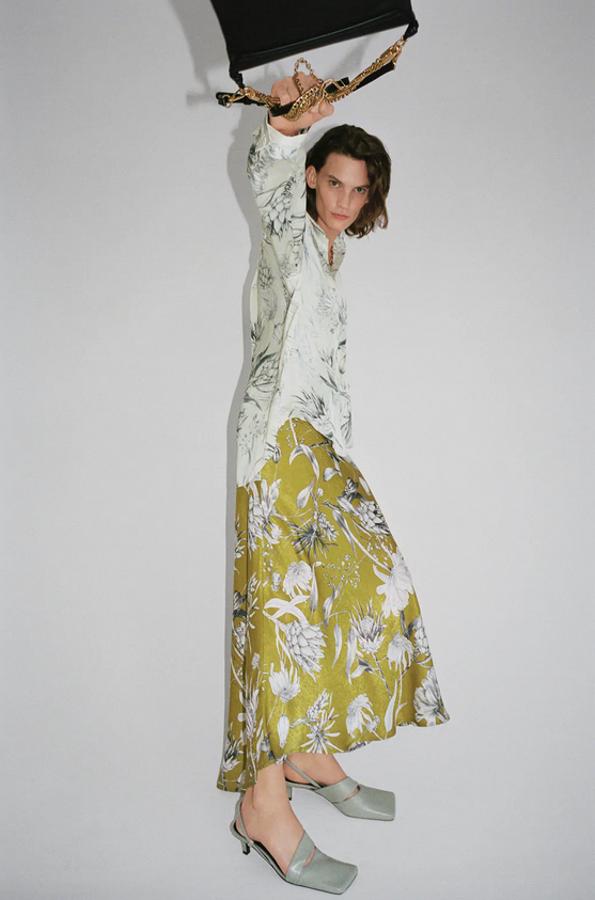 Esta falda fluida de Zara en color lima viene con estampado de flores en tonos blancos y negros. Con cinturón combinado a tono y cierre lateral de cremallera, cuesta 29,95 euros y está disponible entre las tallas XS y XL.