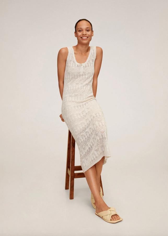 En gris claro, confeccionado en mezcla de lino y con detalles calados, este vestido midi de diseño entallado viene con cuello redondo, tirantes anchos y cierre de botones en el escote. Tiene un precio de 29,99 euros y está disponible únicamente en las tallas XS y S en Mango.