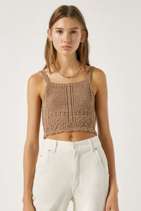 Este top cropped de tirantes en color marrón en tejido de punto cortado cuenta con escote recto, es de Pull & Bear y tiene un precio de 12,99 euros.