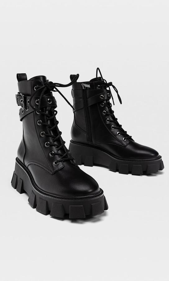 Estos botines militares en colore negro cuentan con tiras cruzadas con hebilla y suela con plataforma. Con cierre mediante cordones y cremallera interior, tienen un precio de 45,99 euros.