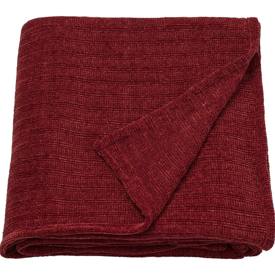 Disponible en marrón rojizo o gris oscuro, esta manta de chenilla de tacto suave y agradable mide 130x170 centímetros y tiene un precio de 13 euros.