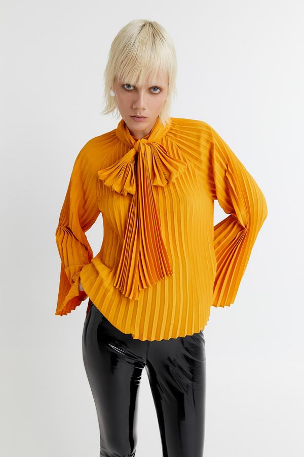 Blusa plisada con lazada al cuello y mangas anchas, de Sfera (29,99 €).