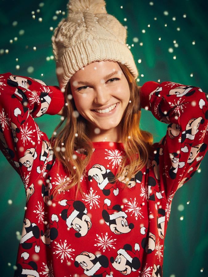Estampado de Mickey Mouse navideño sobre fondo rojo y copos de nieve para esta sudadera roja que podemos encontrar entre las tallas S y XL por 12,99 euros.