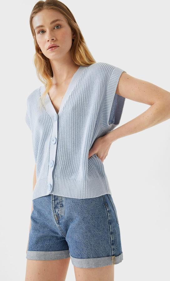 Con cierre frontal con botones, escote de pico y manga sisa, este chaleco en azul celeste de Stradivarius tiene un precio de 15,99 euros y está disponible en las tallas XS, S y M.