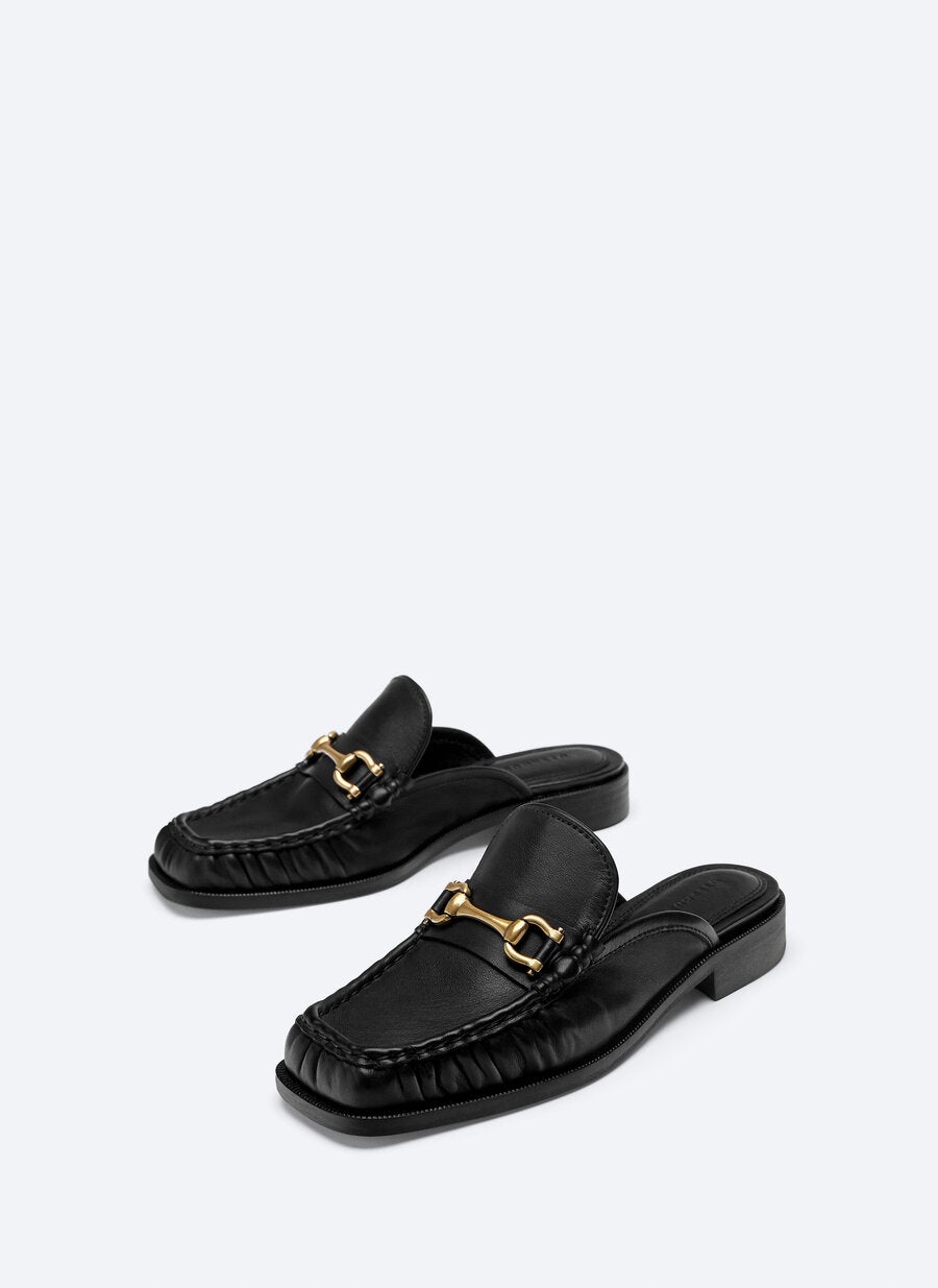 Mocasines tipo mules en negro de Uterqüe. (89 euros).