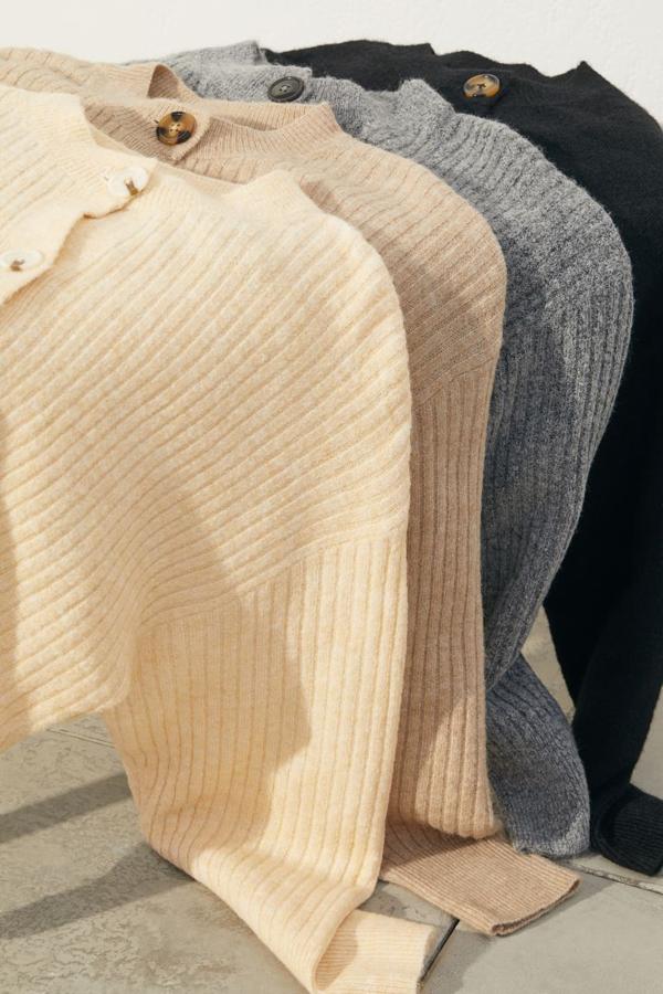 Disponible en negro, beige, gris y amarillo, este cardigan confeccionado con poliéster reciclado en punto de canalé suave con lana en la trama tiene diseño de hombros caídos, cuello redondo y cierre de botones a contraste en el frontal. Tiene un precio de 19,99 euros y está disponible entre las tallas XS y XXL.