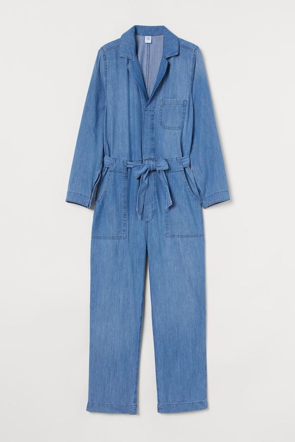 De manga larga y en tejido denim de color azul, este mono confeccionado en algodón reciclado cuenta con escote de pico con cierre oculto de botones, bolsillos y cinturón de anudar extraíble. Tiene un precio de 29,99 euros.