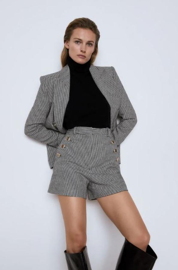 Un clásico reinventado en la nueva colección de Zara: el traje de inspiración masculina con estampado pata de gallo, pero en versión 'shorts' con cintura marcada (25.95 euros). La blazer entallada cuesta 49.95 euros.