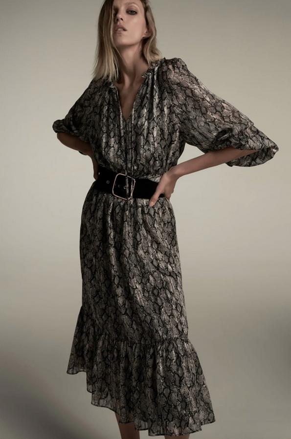 Con escote de pico y cuello redondo con cordón, este vestido midi con mangas largas acabadas en puño elástico y volante es de Zara y viene con cintura elástica con cinturón con hebilla metálica y bajo acabado en volante. Cuesta 39,95 euros y está disponible entre las tallas XS y XXL.