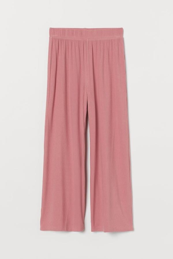 En diseño midi en punto de canalé de viscosa suave, este pantalón de H&M en rosa de antaño es de talle alto y viene con elástico revestido en la cintura y perneras amplias de corte recto. Disponible entre las tallas XXS y XL, cuesta 14,99 euros.