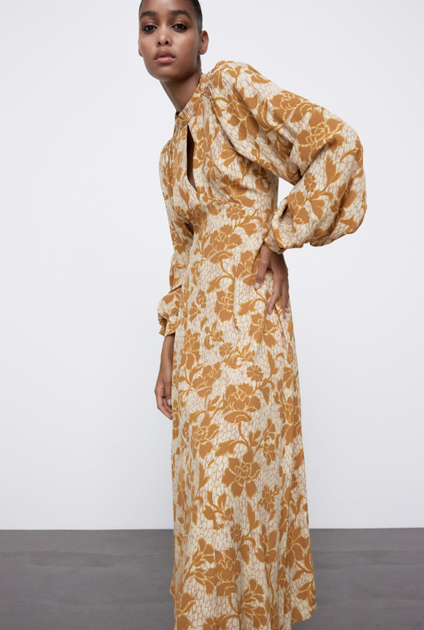 Uno de los vestidos más sofisticados y lujosos que hemos visto en la nueva colección de Zara (39,95 euros). Se trata de un diseoñ midi con el cuello redondo, abertura en el delantero y unas mangas abullonadas espectaculares. El estampado floral, grande y de color mostaza, es maravilloso.