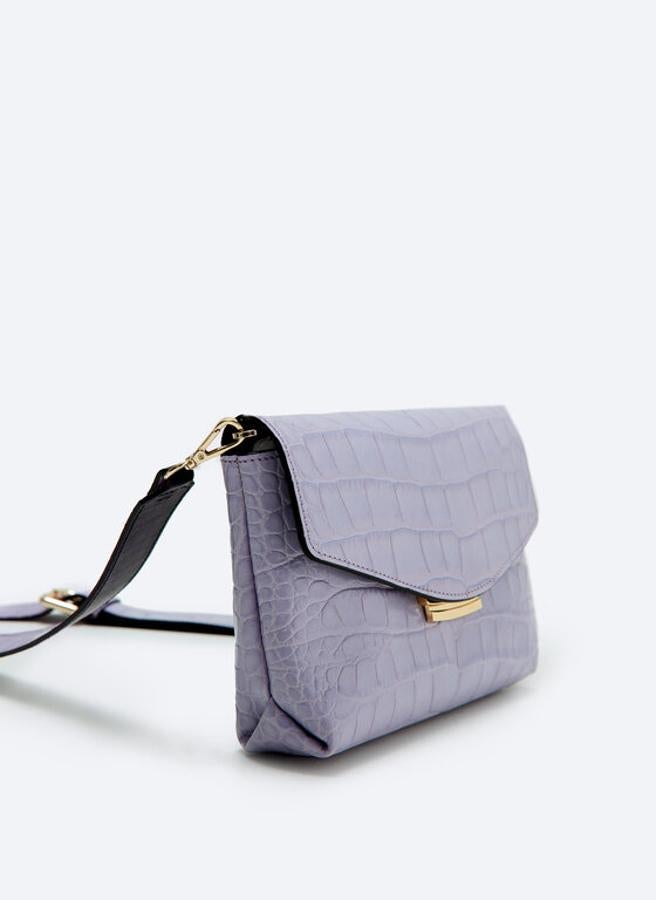 Diseño bandolera para este bolso de Uterqüe con diseño en efecto cocodrilo, con cierre de solapa y cierre metálico en dorado y asa larga extraíble. Cuesta 129 euros.