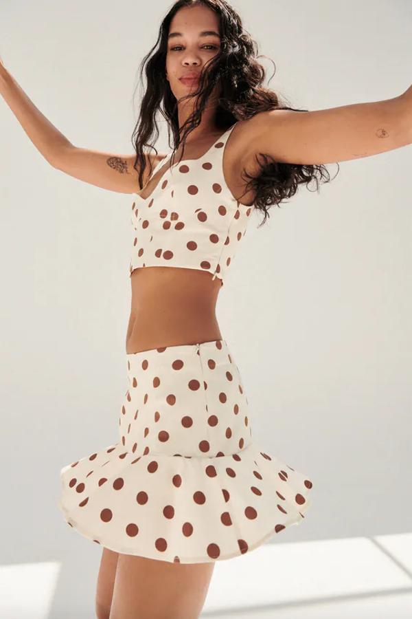 Diseño mini para esta falda confeccionada en tejido con mezcla de lino y tiro alto en color crema con lunares marrones. Con forro interior tipo shorts y volante en el bajo, tiene un precio de 22,95 euros y podemos encontrarla entre las tallas XS y XL.