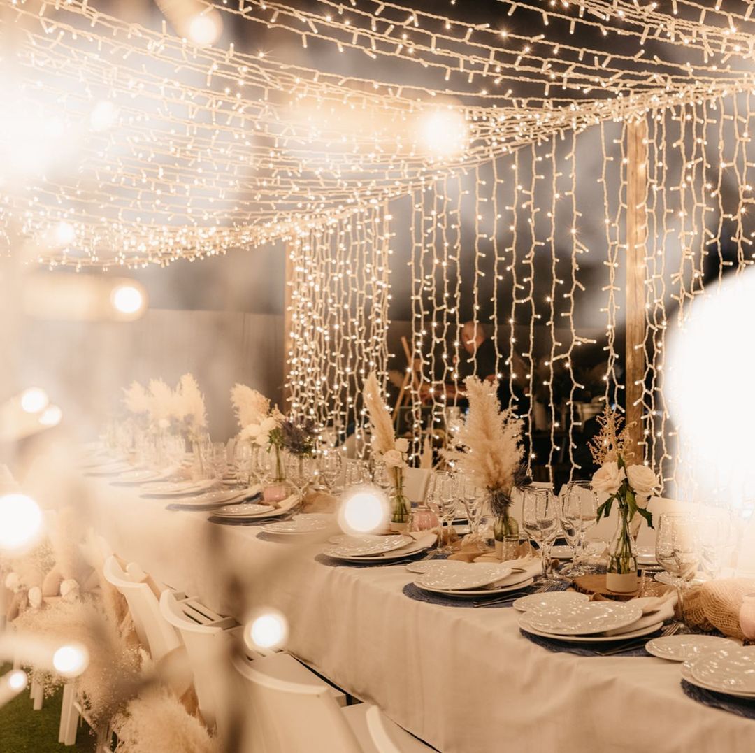 La iluminación es la gran protagonista de la imponente decoración de esta boda de invierno en la que el blanco (de las mantelerías a las vajillas, el mobiliario o los arreglos florales) actúa como hilo conductor.