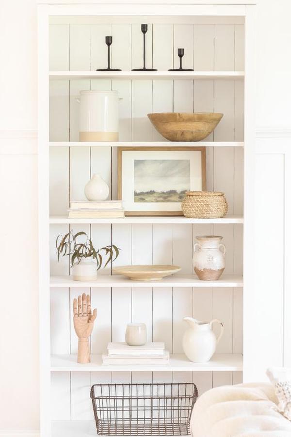 En este caso, un gesto tan sencillo como cambiar la trasera lisa por una delistones de madera es suficiente para transformar una estantería barata en un mueble sofisticado.